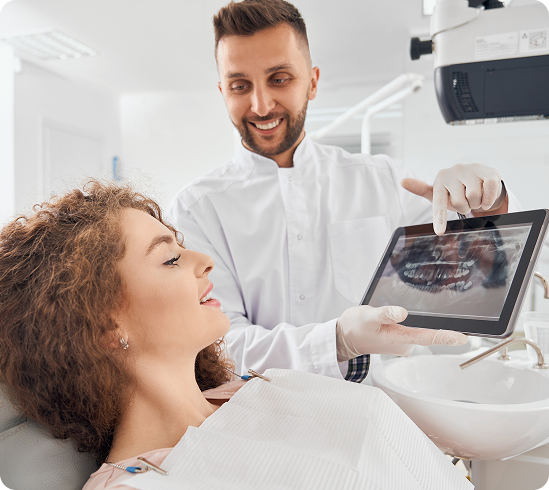 male-doctor-showing-xray-pictures-teeth-tablet 1